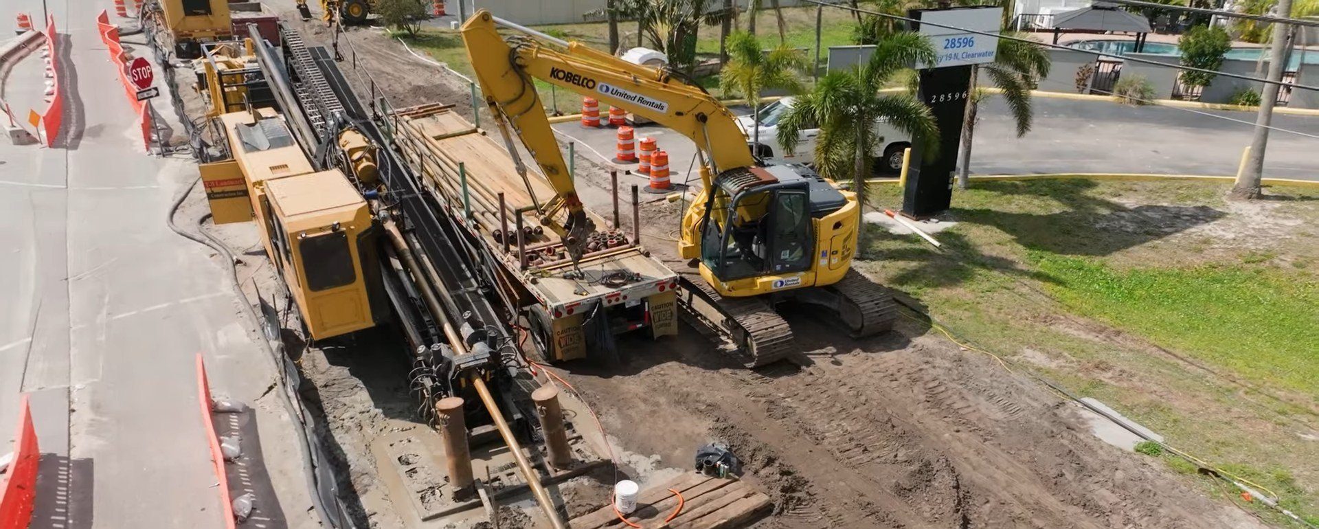 Aerial view of a TB Landmark directional drilling rig and excavator on a Clearwater, Florida jobsite